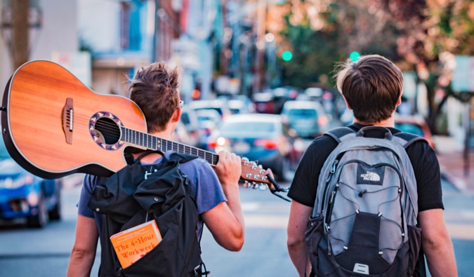 two backpackers with a guitar