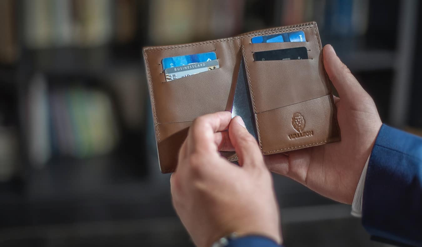 a person reaching for a credit card in their wallet