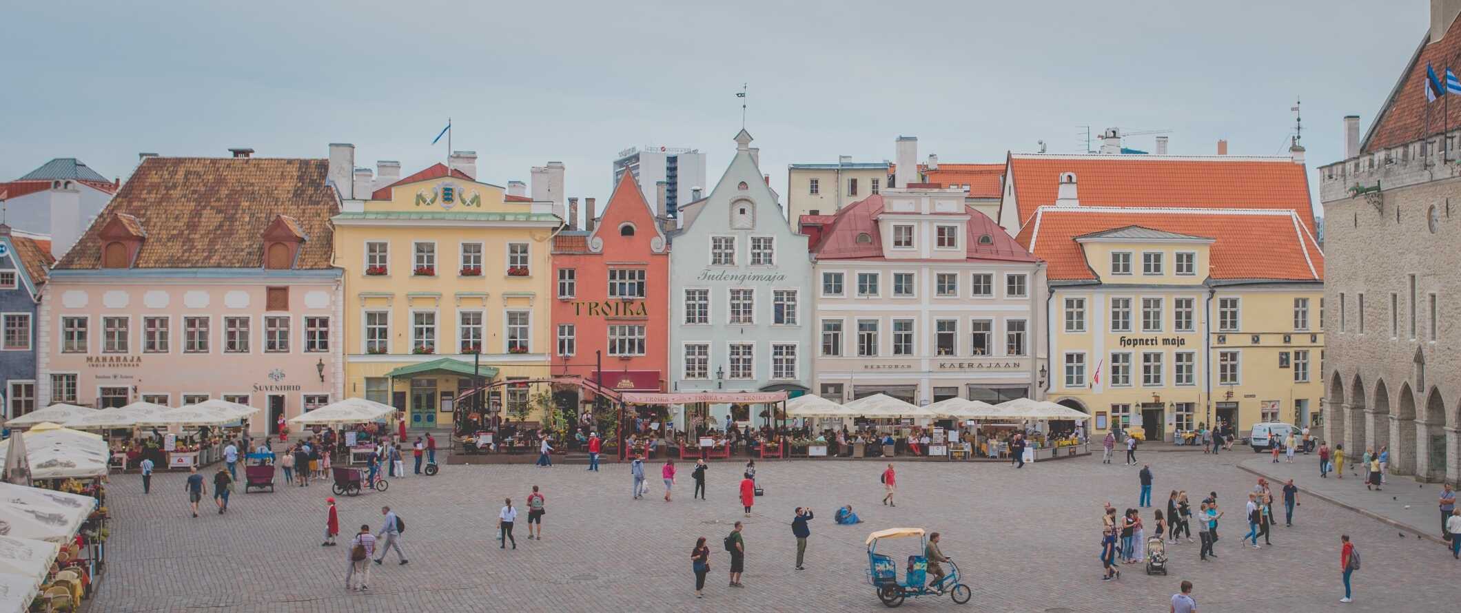 The central square lined with pastel-colored buildings in the Old Town of Tallinn, Estonia