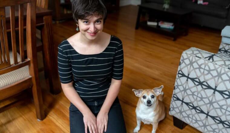 Sam, the lead researcher for Nomadic Matt, posing with a dog while house sitting