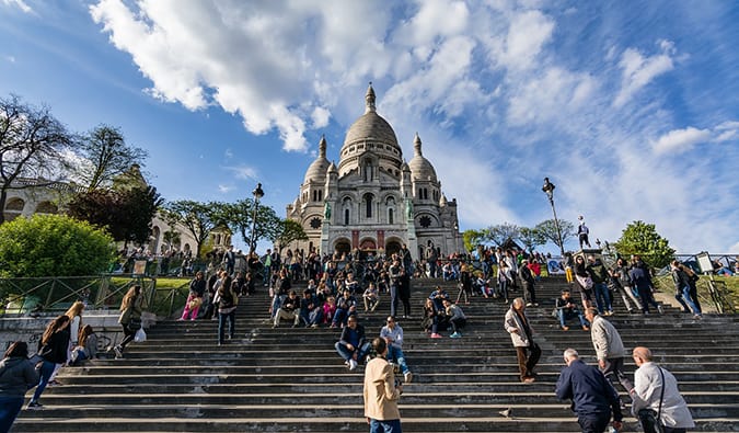 The famous stairs at Sacre Coeur filled with people in Montmartre, Paris