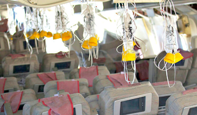 oxygen masks on a plane hanging down over the seats