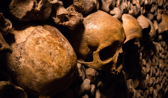 The old bones and skulls of the dark Catacombs in Paris, France