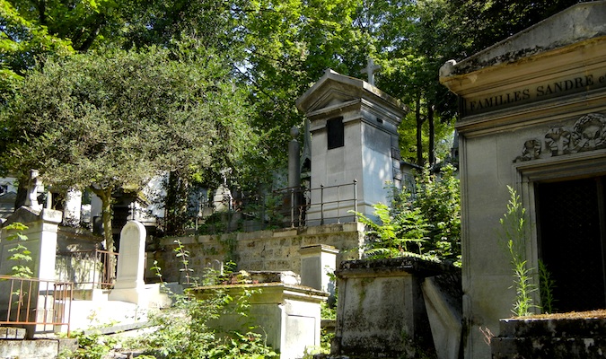 grand tombstones at a massive cemetery in Paris, France