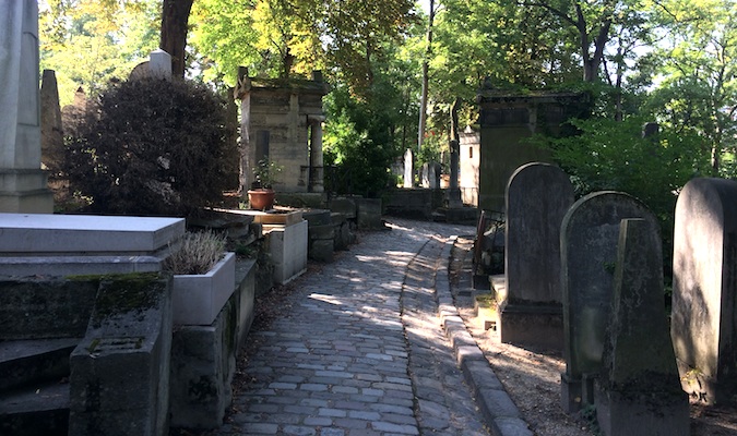 Beautiful haunting pathway through French graveyard in Paris, France