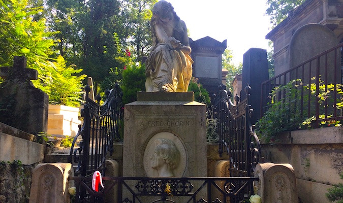 Sad statue of a woman mourning at Pere Lachaise graveyard in Paris, France