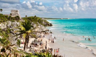 The famous beaches of Tulum, Mexico with Mayan ruins looming on the cliff above