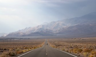 A car driving an open road in Death Valley, USA